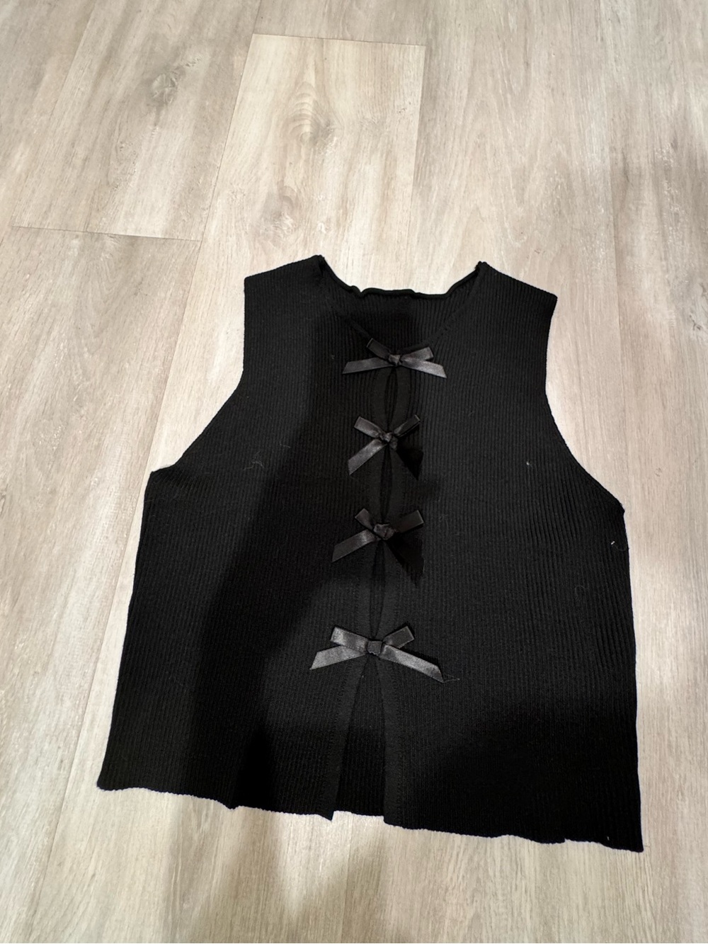 Black Sleeveless Knit Top with Decorative Bows